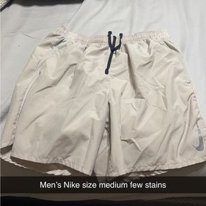 Men’s tan Nike shorts, size medium